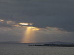 SX05561 Rays of setting sun on mumbles behind Porthcawl harbour.jpg